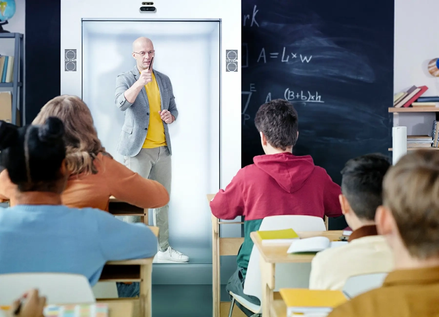 Educator using Proto Hologram’s The Epic to teach students in a classroom setting. Educator using Proto Hologram’s The Epic to teach students in a classroom setting.